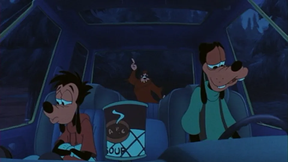 Goofy drives at night while a tired Max slumps in the passenger seat beside a tin of soup, with Bigfoot in the back seat raising a finger